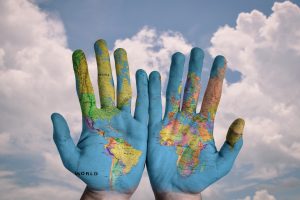 hands with world map languages